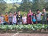 The next generation of COMSA innovators proudly display their organic, raised-bed vegetable gardens.