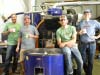 Pictured here (from left to right), Sales Manager Mark Siegfried, Owner Glenn Lathrop, Production Assistant Ronnie Hardt and Roaster Zachary Ray.  “The Desert Sun crew takes a break in front of “Big Blue” their hard-working Diedrich 30 - the MACHINE that churns out their daily brew!