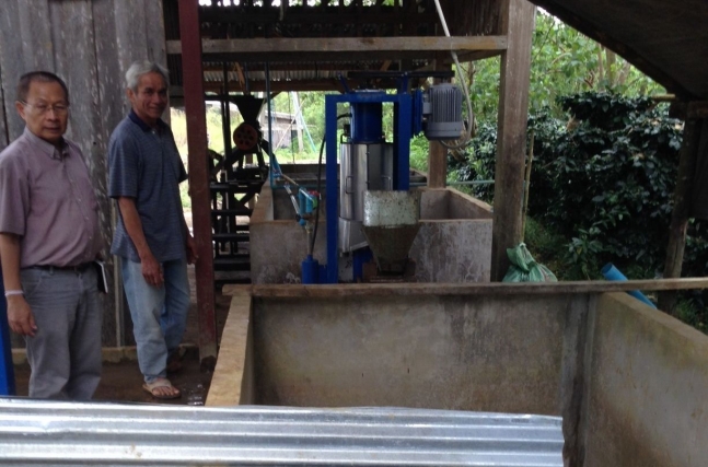 Kali, the wet processing manager for Village at Km11, is proud to show their new equipment and fermentation tanks.